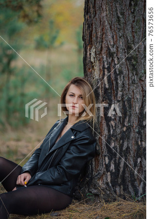 Beautiful woman portrait in forest in autumn. Beautiful woman portrait in forest in autumn. 76573656