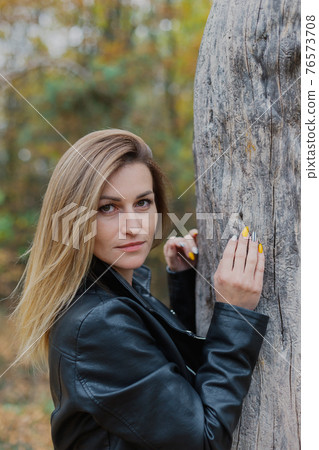 Beautiful woman portrait in forest in autumn. Beautiful woman portrait in forest in autumn. 76573708