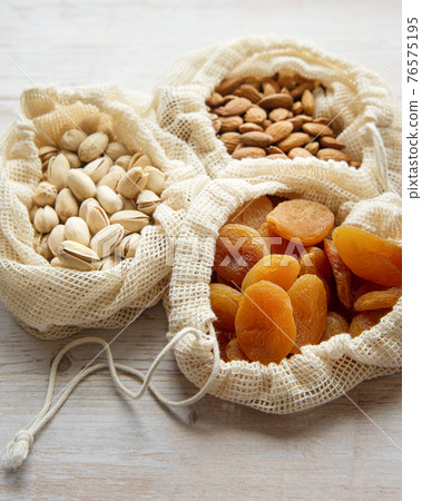 Eco bags with pistachios, almonds and dried apricots 76575195