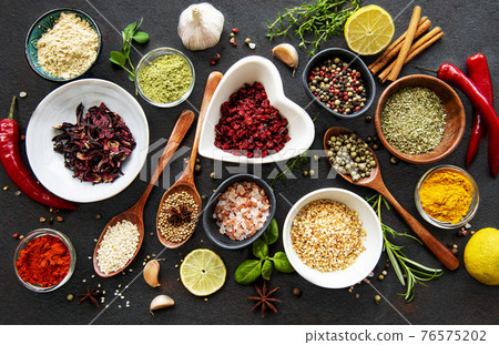 Various spices in a bowls on a black Various spices in a bowls on a black 76575202