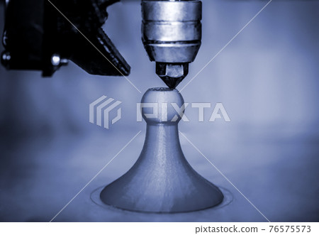 Modern 3D printer printing figure blue colors close-up 76575573