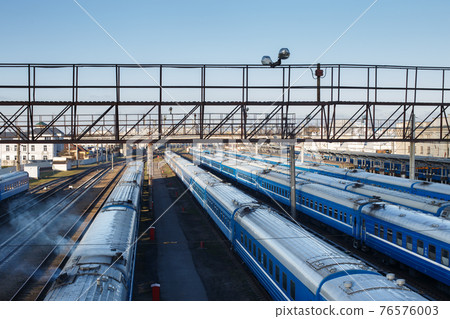 Cargo freight station with many passenger trains 76576003