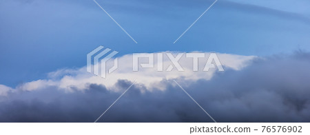 View of Puffy Clouds over the Canadian Mountain Landscape. View of Puffy Clouds over the Canadian Mountain Landscape. 76576902