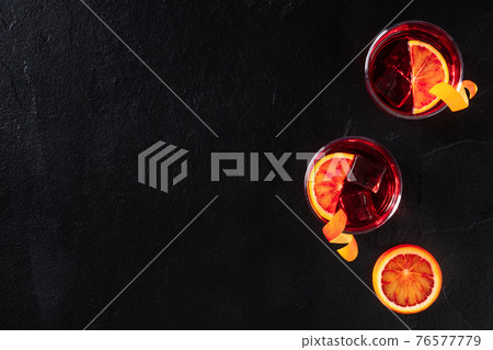 Negroni cocktails with blood oranges and copy space Negroni cocktails with blood oranges and copy space 76577779