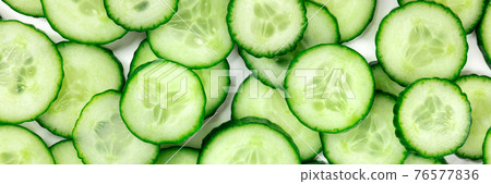 Cucumber panorama with many vibrant cucumber slices 76577836