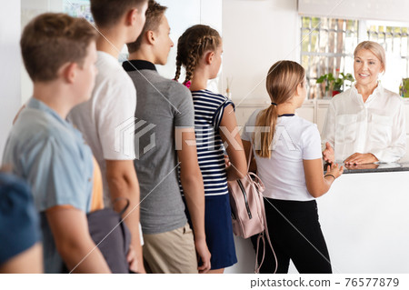 School boys and girls standing in line near cloackroom School boys and girls standing in line near cloackroom 76577879