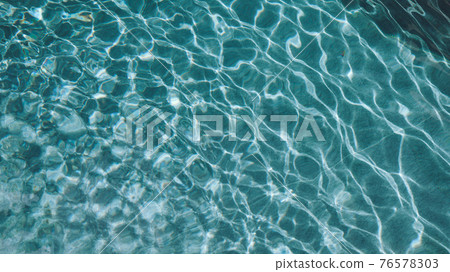 Abstract pool water. Swimming pool bottom caustics ripple and flow with waves background surface of blue swimming pool Abstract pool water. Swimming pool bottom caustics ripple and flow with waves background surface of blue swimming pool 76578303