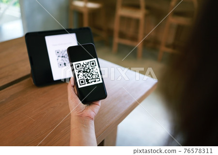 Qr code payment. Woman scanning QR code online shopping cashless technology concept. Qr code payment. Woman scanning QR code online shopping cashless technology concept. 76578311