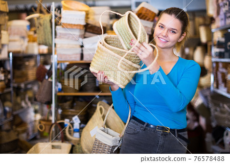 girl buyer standing with wicker baskets girl buyer standing with wicker baskets 76578488