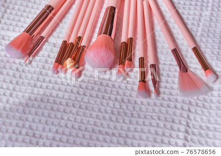 Wet make up brushes on towel, closeup 76578656