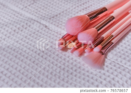 Wet make up brushes on towel, closeup 76578657