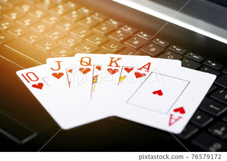 Online gaming platform, casino and gambling business. Poker cards on laptop keyboard 76579172