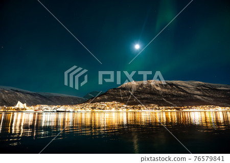 Drinking hot wine outside at night near the full moon 76579841