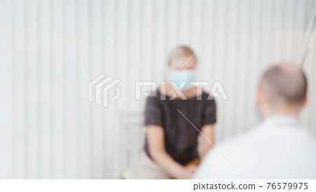 blurry image of a doctor consulting a mature woman . blurry image of a doctor consulting a mature woman . 76579975