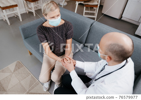doctor calming an agitated patient during a home visit. doctor calming an agitated patient during a home visit. 76579977