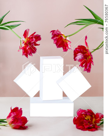 Gift or present box wrapped in white paper and tulip flowers on pink table. Copy space Gift or present box wrapped in white paper and tulip flowers on pink table. Copy space 76580367