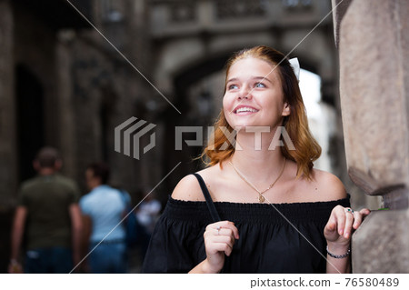 young positive female in the city center 76580489