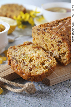 Traditional English tea raisins cake, egg-free cake and cup of lemon tea Traditional English tea raisins cake, egg-free cake and cup of lemon tea 76580793