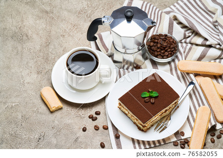 Portion of Traditional Italian Tiramisu dessert and savoiardi cookies on grey concrete background 76582055