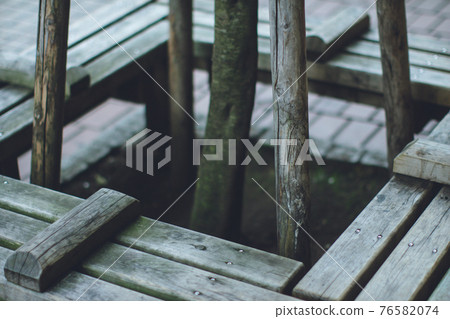 Bench by the tree 76582074