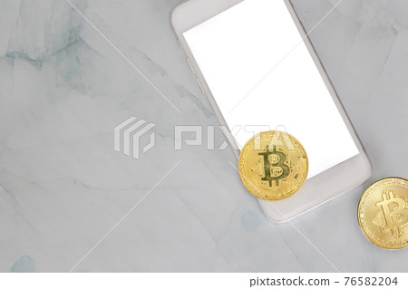 golden bitcoin lies on a smartphone on marble background top view with copy space, cryptocurrency or digital money concept , blacnk mobile phone golden bitcoin lies on a smartphone on marble background top view with copy space, cryptocurrency or digital money concept , blacnk mobile phone 76582204