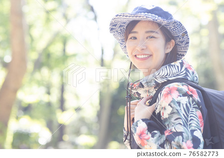 一個女人在新鮮的綠色森林裡享受徒步旅行 76582773