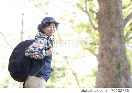 一個女人在新鮮的綠色森林裡享受徒步旅行 一個女人在新鮮的綠色森林裡享受徒步旅行 76582776