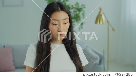 Portrait of asian chinese young woman smiling,happy woman smile looking at the camera at home. Leisure concept. Close up. 76584296