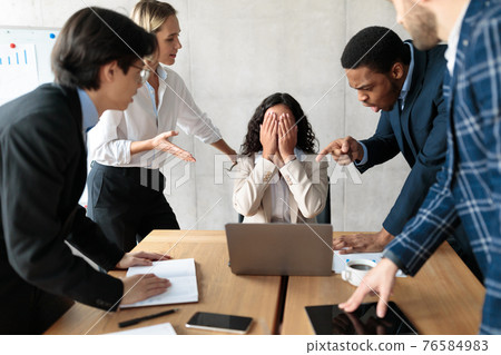 Displeased Business People Shouting At Unhappy Female Employee In Office Displeased Business People Shouting At Unhappy Female Employee In Office 76584983