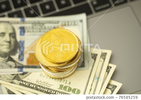 Ethereum coins on a dollars and on a laptop. Trading on the cryptocurrency exchange. Cryptocurrency Stock Market Concept. Mining or blockchain technology. Business concept. Ethereum coins on a dollars and on a laptop. Trading on the cryptocurrency exchange. Cryptocurrency Stock Market Concept. Mining or blockchain technology. Business concept. 76585259