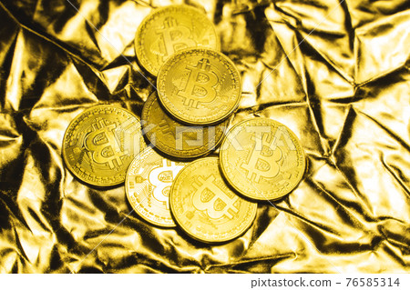Golden bitcoin Coins on a golden background. Trading on the cryptocurrency exchange. Cryptocurrency Stock Market Concept. Virtual money concept. Mining or blockchain technology. Business concept. 76585314