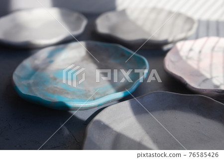 Pile set of Stone curl color platter on gray conrete table Pile set of Stone curl color platter on gray conrete table 76585426