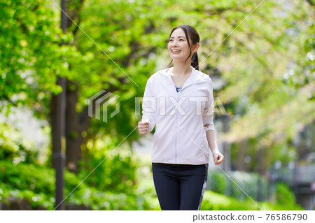 Young woman jogging with a smile Young woman jogging with a smile 76586790