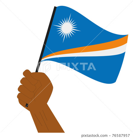 Hand holding and raising the national flag of Marshall Islands Hand holding and raising the national flag of Marshall Islands 76587957
