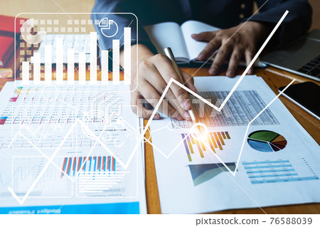 Close up Businessman hand holding pen and pointing at financial paperwork with financial network diagram. Close up Businessman hand holding pen and pointing at financial paperwork with financial network diagram. 76588039