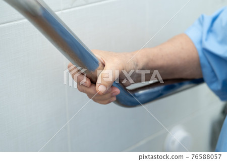 Asian senior or elderly old lady woman patient use toilet bathroom handle security in nursing hospital ward 76588057