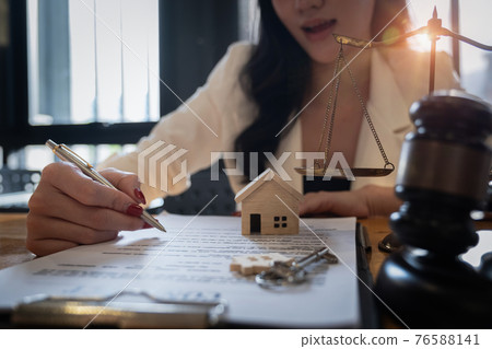 Lawyer checking agreement document before sending to client. 76588141