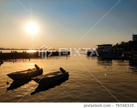 Boat at sunset 76588320