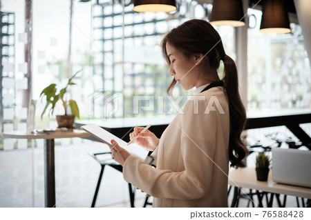 Businesswoman owner make ads. Open now on social media. Cafe or restaurant and business reopen after COVID-19 quarantine is over. 76588428