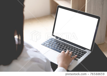 Asian woman using laptop computer mockup and blank screen with morning light at home office. Asian woman using laptop computer mockup and blank screen with morning light at home office. 76588659