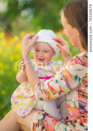 Happy woman and child on the poppy meadow. Happy woman and child on the poppy meadow. 76588679