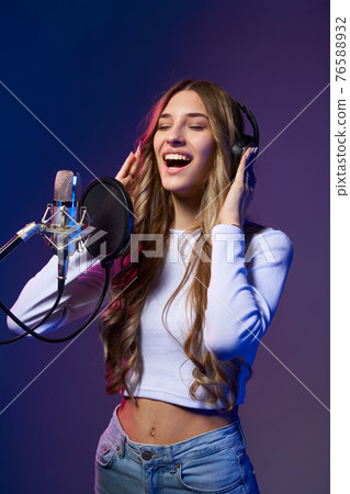 Young Caucasian girl singing enjoying with closed eyes Young Caucasian girl singing enjoying with closed eyes 76588932