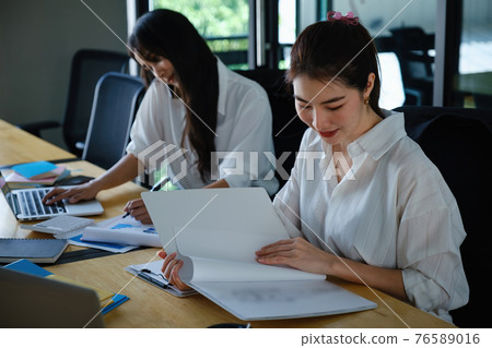 Two of Young business female working together and partners talking with customer. Two of Young business female working together and partners talking with customer. 76589016