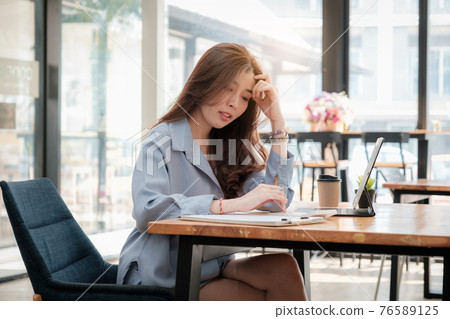 Young asian accountant using calculations. Savings, finances, tax and economy concept. Young asian accountant using calculations. Savings, finances, tax and economy concept. 76589125