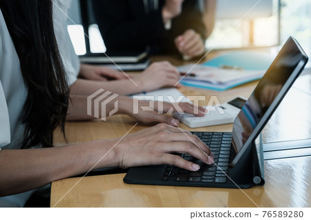 Group of Businessman and Accountant checking data document on digital tablet for investigation of corruption account . Anti Bribery concept. Group of Businessman and Accountant checking data document on digital tablet for investigation of corruption account . Anti Bribery concept. 76589280