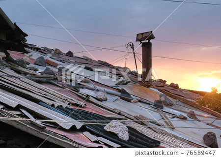 Yerevan, Armenia, Alexander Kirillov - 30082019: Cond, Roof made of pieces of tiles, stones and rusty pipe 76589447