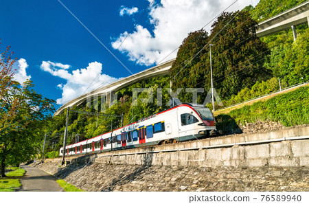 Train at Lake Geneva in Switzerland 76589940