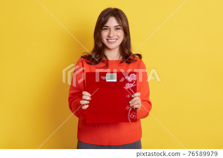 Happy smiling female showing floor scales, being very satisfied with her result, looking directly at camera with positive expression, lady keeps healthy diet and loosing weight. Happy smiling female showing floor scales, being very satisfied with her result, looking directly at camera with positive expression, lady keeps healthy diet and loosing weight. 76589979