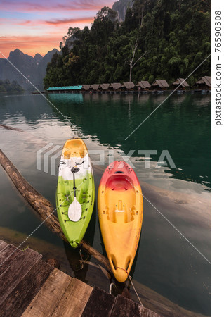 Beautiful morning view with kayak in sunrise sky and natural attractions in Ratchaprapha Dam at Khao Sok National Park 76590308