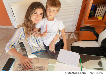 Mother working home with son Mother working home with son 76590497